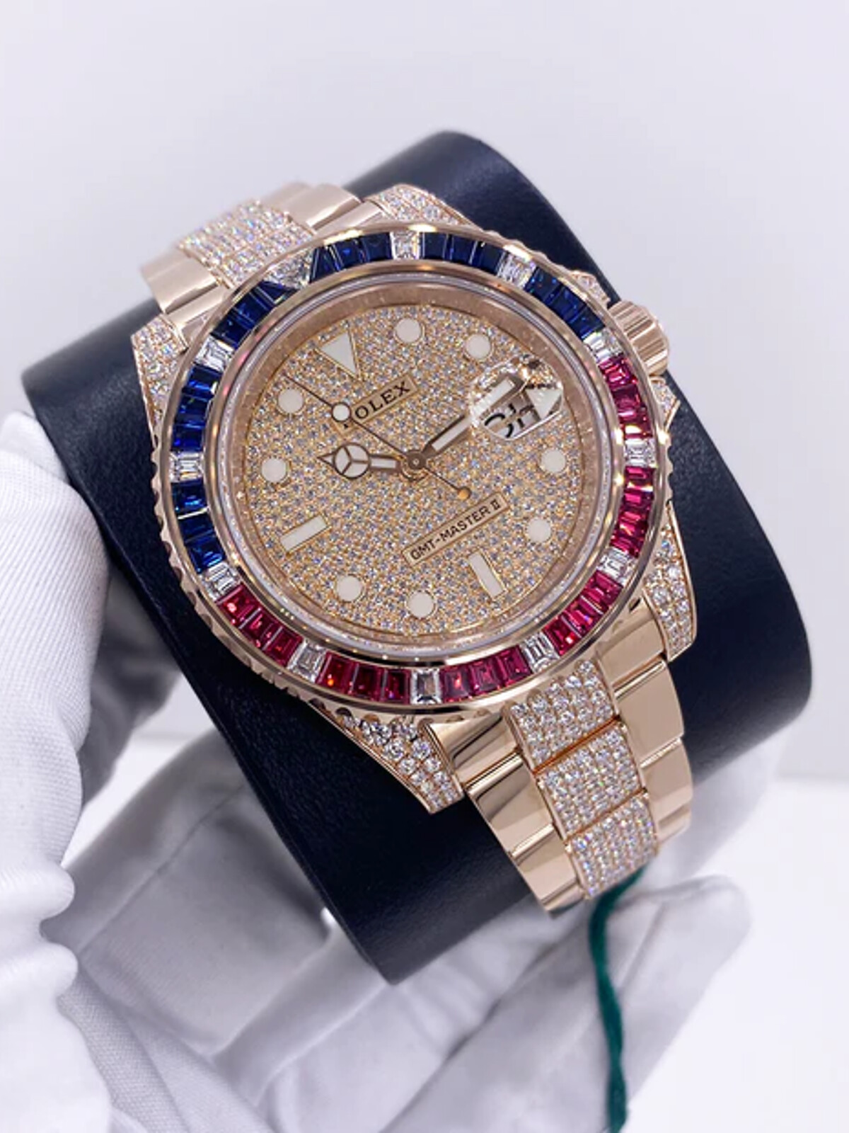 Gem-set Rolex GMT-Master II presented on a watch cushion